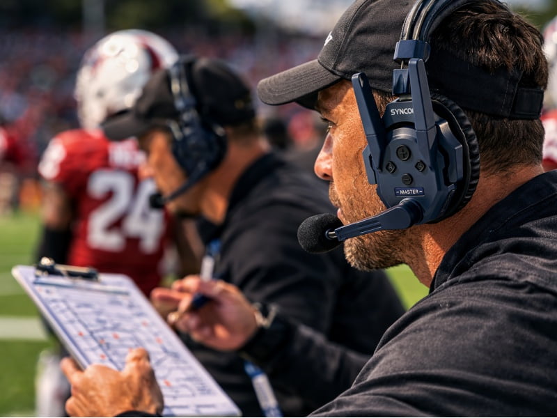 Who are NFL coaches talking to on their headsets?